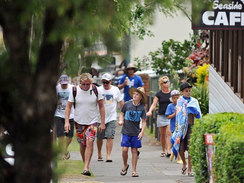 Tourists walking up a street