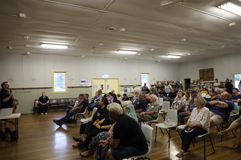 a group of people sitting down at a meeting