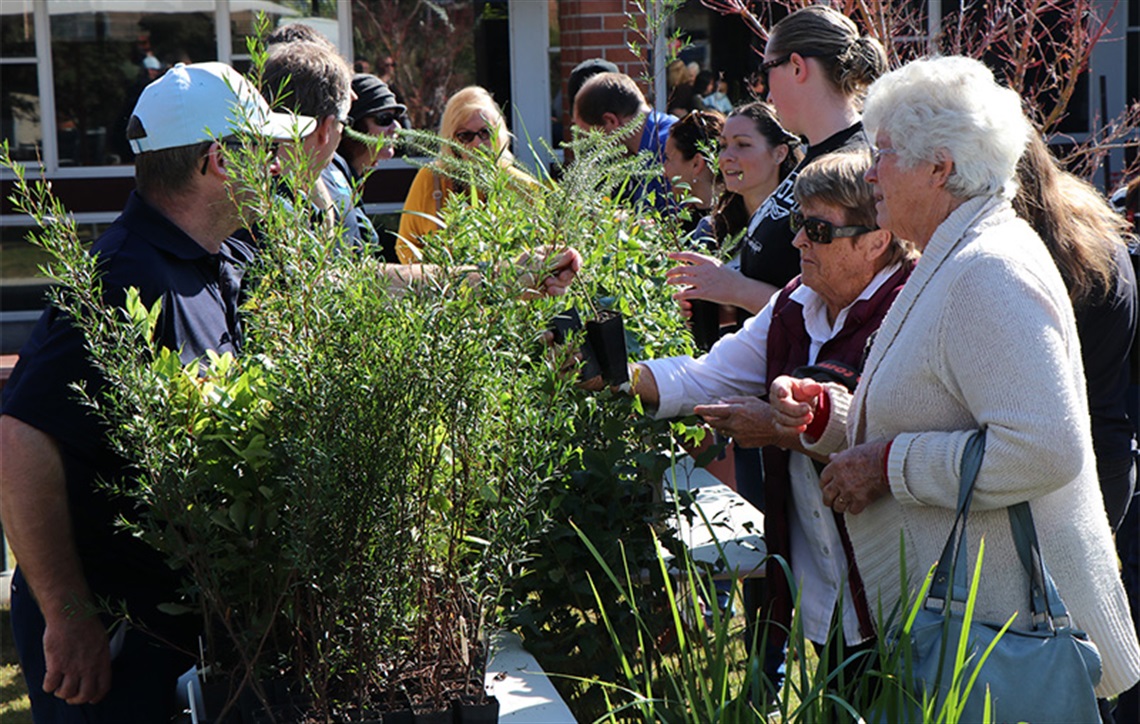 People standing in line to receive a free tree for national tree day