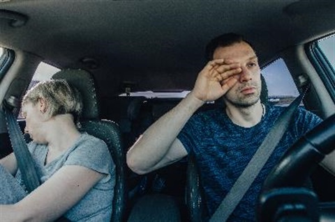 driver rubbing tired eyes