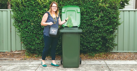 a lady standing next to a bin