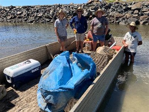 people in boat with rubbish