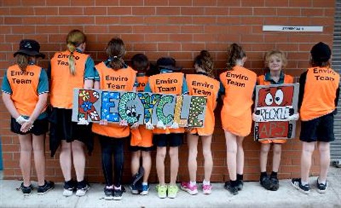 School kids with recycle sign